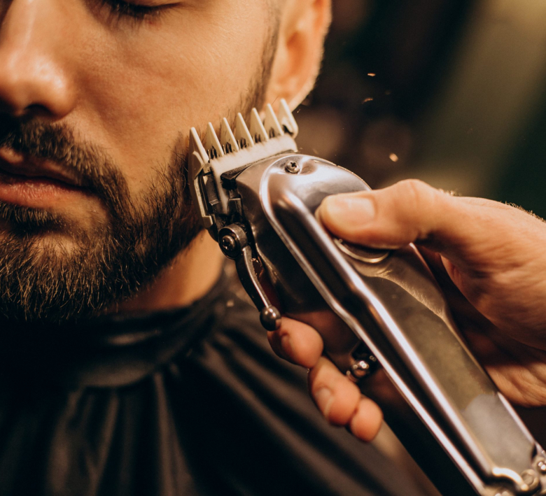 Handsome man at barbershop shaving beard